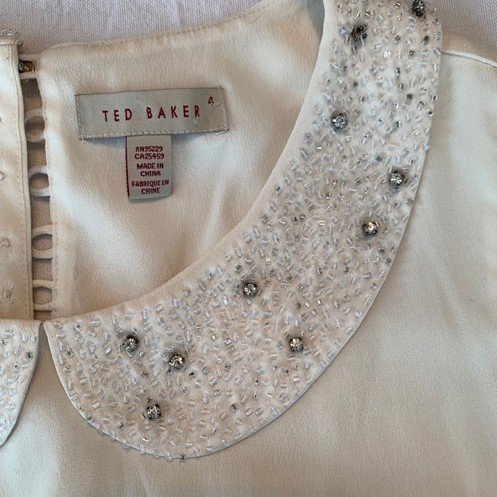 Cream Ted Baker dress with jeweled collar.